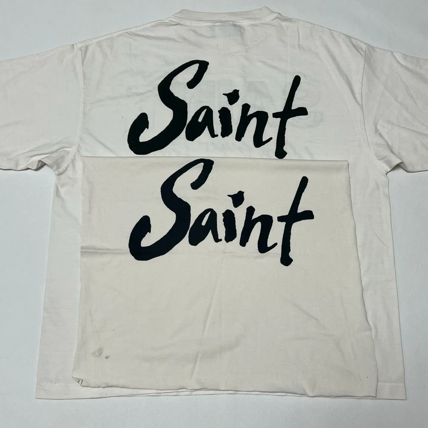 SAINT Mxxxxxx SS TEE/SUPER DIRTY/WHT oil painting SAINT SUPER DIRTY slogan TEE off-white S-XL Made of original OE yarn tube weaving without side seams to distinguish the split fabrics original consistent VINTAGE label/little angel anti-counterfeiting label top printing technology highly restored original details